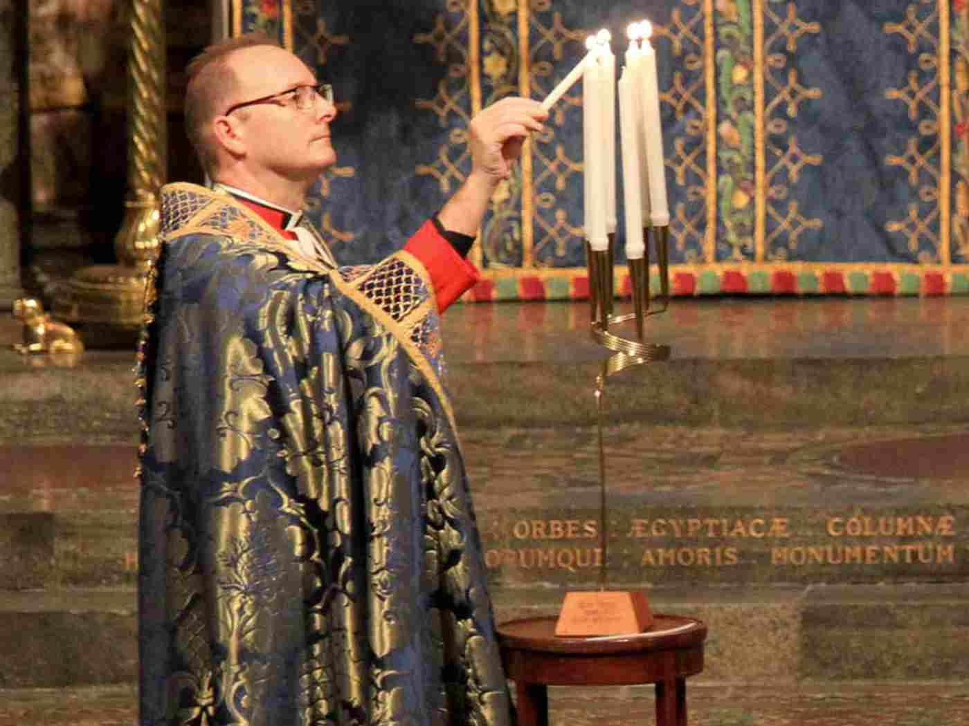 Anthony Ball, Canon in Residence, Westminster Abbey, lights a memorial candle