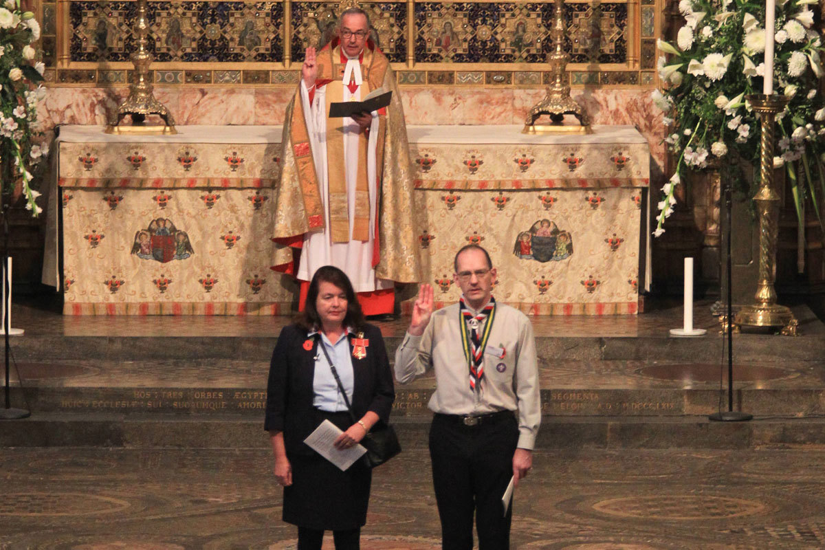 Valerie Le Vaillant, Chief Guide, and Tim Kidd, The Scouts UK Chief Commissioner, renew their Promise, joined by the Dean of Westminster, The Very Reverend Dr John Hall