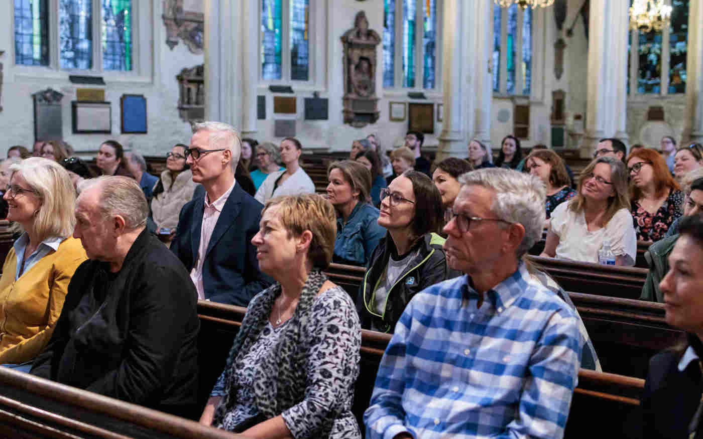 Photograph of lots of people sitting in the pews as audience members for a talk within St Margaret's Church
