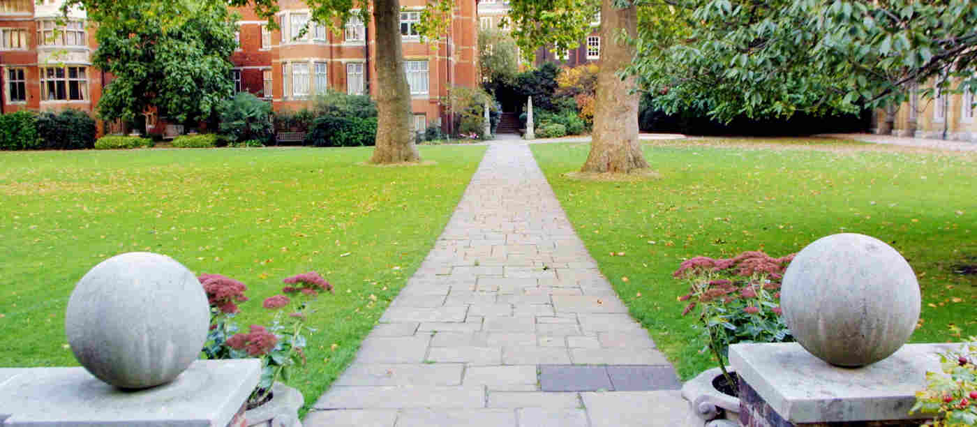 Photograph looking through stone framed entrance to College Garden at Westminster Abbey