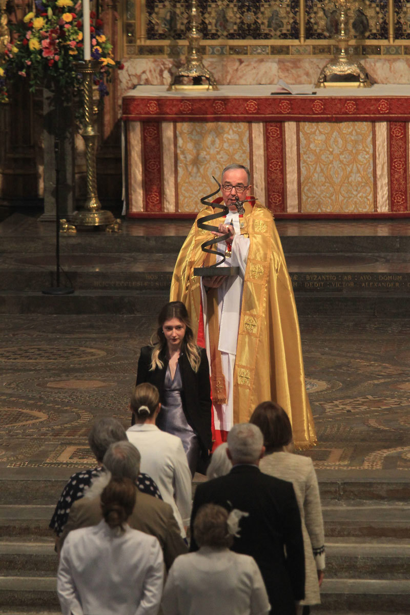 The Dean of Westminster, the Very Reverend Dr John Hall, receives the sculpture 'Strength and Hope' by Annie Tempest, which was borne through the Abbey by DrugFAM volunteers at the start of the service